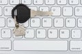 Key with a house keychain on gray keyboard