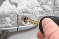 Key inserted into the lock of frozen car door Royalty Free Stock Photo