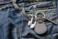 Key with a keychain and headphones in a jeans pocket Royalty Free Stock Photo