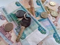 The key with the keychain lies on Russian money. Background with Russian currency and a key Royalty Free Stock Photo