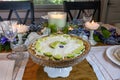 Key lime Cheesecake on an antique cake stand on a table