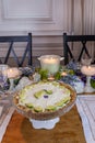 Key lime Cheesecake on an antique cake stand on a table