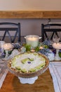 Key lime Cheesecake on an antique cake stand on a table