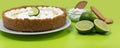 Key lime pie with cookies and limes Royalty Free Stock Photo