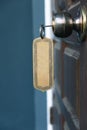 Key with metal empty keyring in wooden door knob Royalty Free Stock Photo