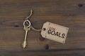 Key and a note on a wooden table with text - 2016 goals. New Yea Royalty Free Stock Photo