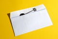 key in open mail envelop on yellow background. concept of solution, success, opportunity Royalty Free Stock Photo