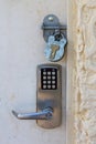 A key pad and padlock locked on the front of a door Royalty Free Stock Photo