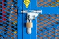 A key padlock locking on the hand tool storage box - Industrial equipment.