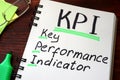 Key Performance Indicators KPI written on a notepad.