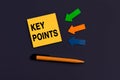 KEY POINTS - concept of text on sticky note. Business concept. Orange square sticky note, pen and colorful arrows on dark blue