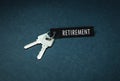 Key and retirement word on a blue background.