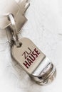 Key ring with two keys and tag with German text Zu Hause (translation: at home) on a white background Royalty Free Stock Photo