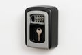 Key safe box hanging on white wall holding a key Royalty Free Stock Photo
