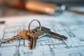 A key set sits on top of architectural blueprints in a workspace, indicating the start of a new construction project. Tools and Royalty Free Stock Photo