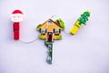 Key in the shape of a house on a white background with Christmas Clothespin Clips Decorative Wooden