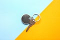 Key with stylish keychain on color background