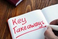 Key takeaways written by man. Royalty Free Stock Photo