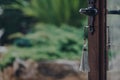 Key with a tassel in the open door leading to the garden