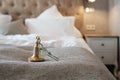 key to the hotel room lies on the bed Royalty Free Stock Photo