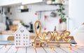 Key to house of cozy home with Valentine decor on table of kitchen. Gift for valentines day, family love nest. Building, design,