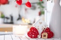 Key to house of cozy home with Valentine decor on table of kitchen. Gift for valentines day, family love nest. Building, design,