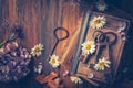 Key to knowledge concept. Old keys on a vintage book with flowers on wooden background Royalty Free Stock Photo