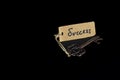 Key to Success concept - Old key with success tag isolated on black background Royalty Free Stock Photo