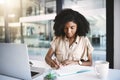 The key to success is staying organized. a young businesswoman writing notes at her desk in a modern office. Royalty Free Stock Photo