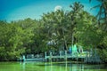 Key West get-away under full moon - Party boat docked near shore and pier in Florida Keys with surfboards lined up under palm Royalty Free Stock Photo