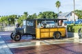 people enjoy the sunset point at Mallory square with drinks mixed in a vintage car in Key West