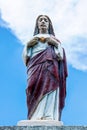 Key West USA - Looking up at Sacred Heart Jesus statue with blue sky and cloud behind Royalty Free Stock Photo