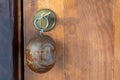 A key with a wooden round keychain inserted into the lock.Selective focus.Close up of key on brown door.Security concept, scenery Royalty Free Stock Photo