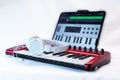 Red midi keyboard with headphones for music production