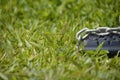 Keyboard chained on grass.