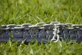 Keyboard chained on grass.