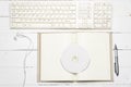 Keyboard computer with open notebook and dvd disc Royalty Free Stock Photo
