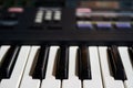 Keyboard of an electric piano, control unit out of focus in the background Royalty Free Stock Photo