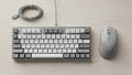 Keyboard with gray and white keys featuring an attached USB cable Royalty Free Stock Photo