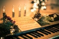 Keyboard with instrumental sheet music and soft lights for Christmas holiday, split tone Royalty Free Stock Photo