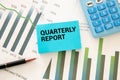 Keyboard of laptop, calcualtor, pencil and notepad with text QUARTERLY REPORT Royalty Free Stock Photo