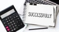 Keyboard of laptop, calcualtor, pencil and notepad with text SUCCESFULLY on the white background Royalty Free Stock Photo