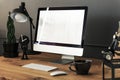 Keyboard, mouse and desktop computer on wooden desk with lamp in Royalty Free Stock Photo