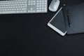 Keyboard, mouse, digital tablet, pen and organizer on black background Royalty Free Stock Photo