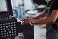 Keyboard, mouse, hands. Man at the workshop in uniform use computer for his job for fixing broken car Royalty Free Stock Photo