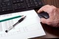 Keyboard, mouse in man`s hand, papers, pen and pencil