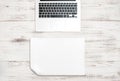 Keyboard over wooden desk. Paper background. Office workspace