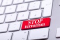 Keyboard with red button and stop terrorism word on it Royalty Free Stock Photo