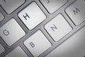 Keyboard - silver portable computer keyboard in IT department with letter H isolated on white button