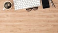 Keyboard, smartphone and coffee cup on wooden table, top view with copy space, 3d illustration